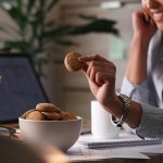 close up businesswoman eating cookies break her office 1
